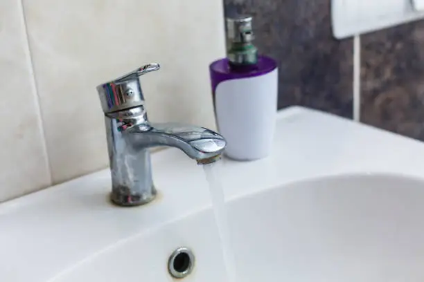 Photo of Faucet tap with flowing water