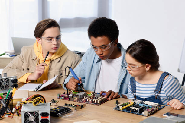 istock multicultural teenagers soldering computer circuit with soldering iron at home 1016589562