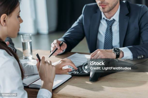 Cropped Shot Of Businessman And Businesswoman Using Conference At Modern Office Stock Photo - Download Image Now