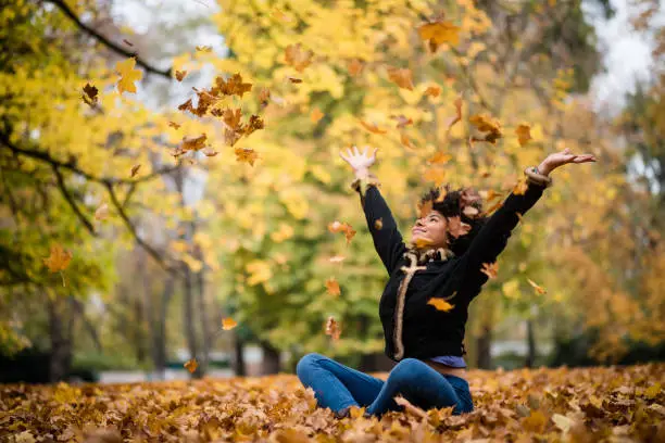 Teenage girl having fun during the autumn season