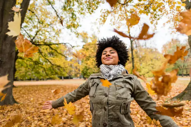 African american woman enjoying autumn season