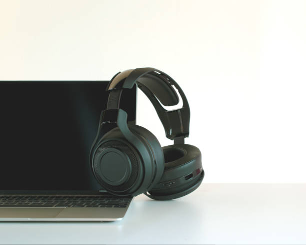 istock Headphones black and laptop on Work Desk. 1016605424