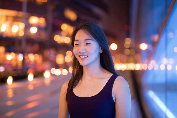 istock Happy Asian Woman Thinking Outdoors At Night 1016605646