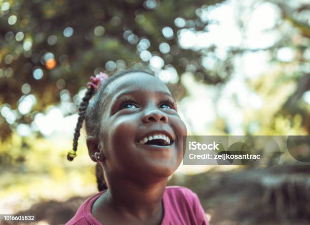 Portrait Of A Cute Little African Girl Stock Photo - Download Image Now - Child, Looking Up, Africa