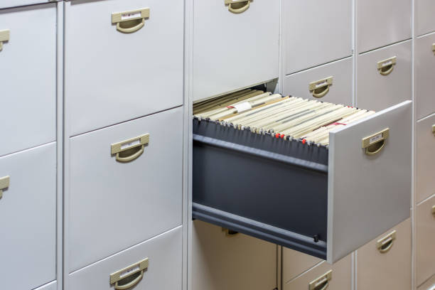 file cabinet with a wide open drawer full of files - open concept audio imagens e fotografias de stock