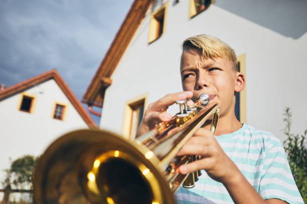 istock Little boy playing the trumpet 1016620770