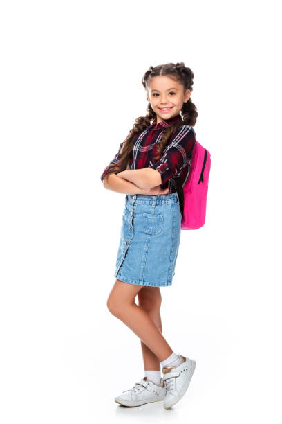 istock schoolchild with pink backpack standing with crossed arms isolated on white 1016623020