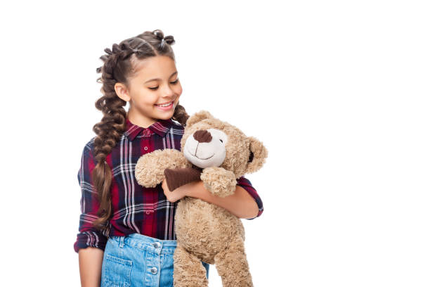 istock smiling schoolchild holding teddy bear isolated on white 1016623024