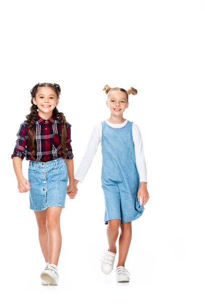istock schoolchildren walking and holding hands isolated on white 1016623056