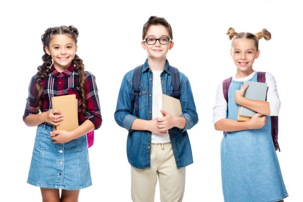 istock three smiling classmates holding books and looking at camera isolated on white 1016623310