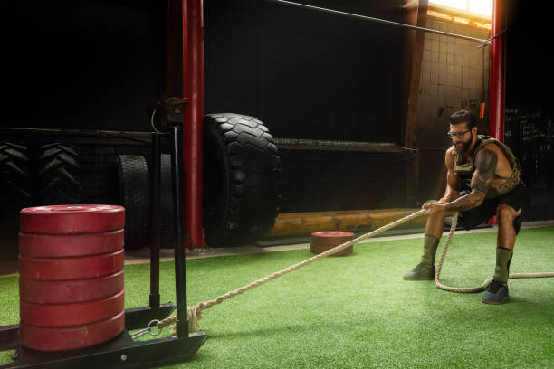 istock Sled drag exercise. Sportsman during his cross training workout. 1016623316