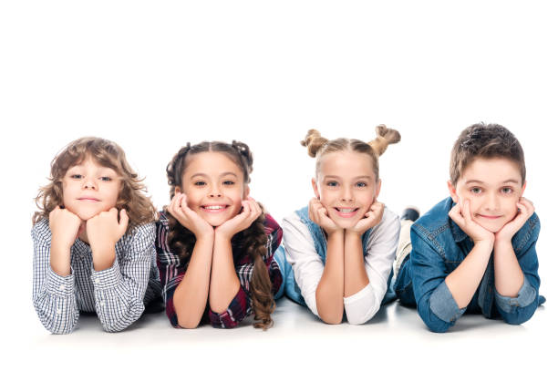 istock smiling classmates lying and resting chins on hands isolated on white 1016623444