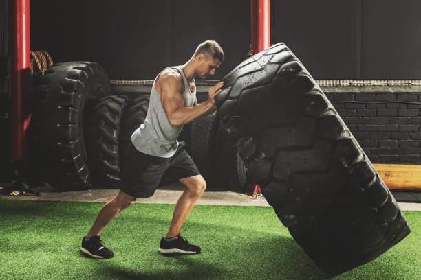 istock Strong sportsman doing  a tire flip exercise 1016624080