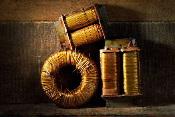 Three old copper wire coils. stock photo