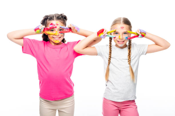 istock smiling schoolchildren looking through painted fingers isolated on white 1016640928
