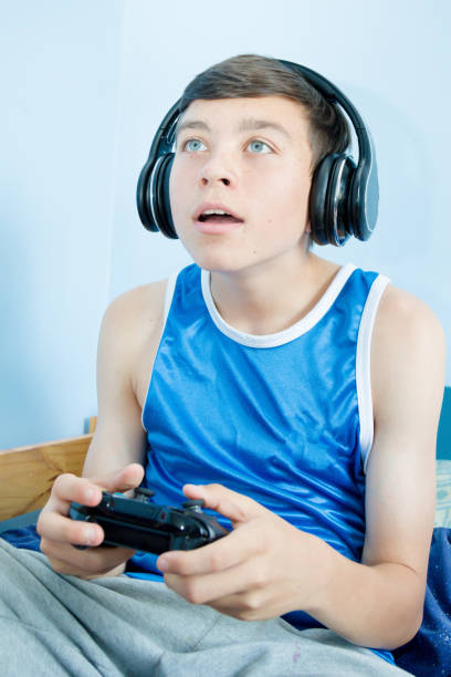 istock Teenage boy playing a video game 1016644042