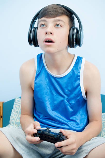 istock Teenage boy playing a video game 1016644046