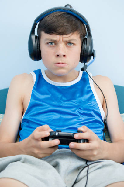 istock Teenage boy playing a video game 1016644982