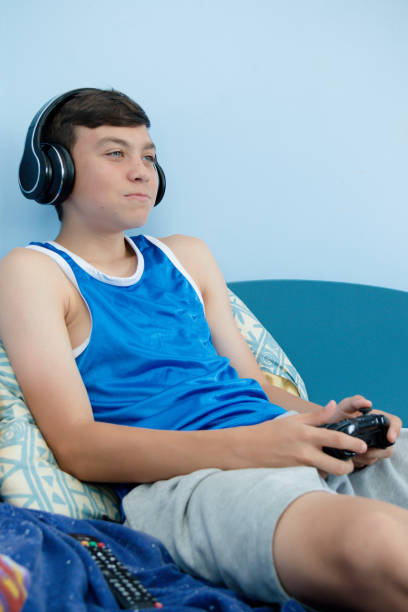 istock Teenage boy playing a video game 1016647228