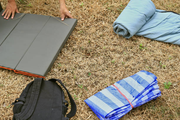 Camping equipment Sleeping bag People are rolls sleeping bags to store.