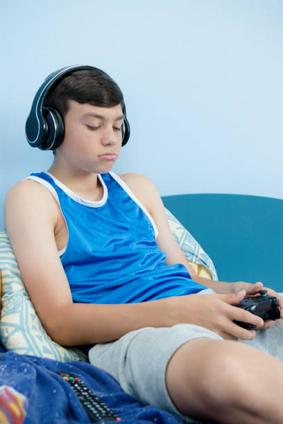 istock Teenage boy playing a video game 1016647636