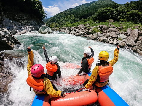 Personal point of view of a group of men and women while white water river rafting