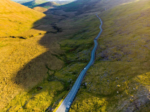 Conor Pass, one of the highest Irish mountain passes served by an asphalted road, located on the Dingle Peninsula, County Kerry, Ireland Aerial view of Conor Pass, one of the highest Irish mountain passes served by an asphalted road, located on the south-western end of the Dingle Peninsula, County Kerry, Ireland dingle peninsula stock pictures, royalty-free photos & images