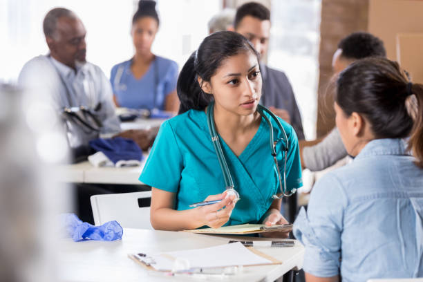 istock Young nurse listens compassionately to new patient 1016651240