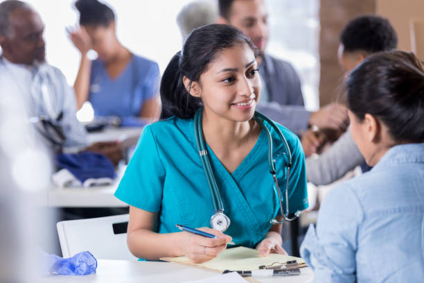 istock Young nurse enjoys helping free clinic patients 1016651266