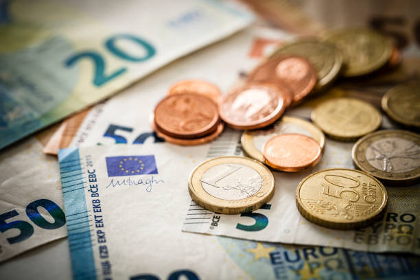 european union banknotes and coins - european union euro note currency forex european union currency imagens e fotografias de stock