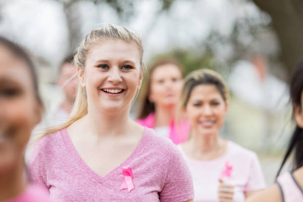 istock Young woman runs in cancer awareness fun run 1016651904