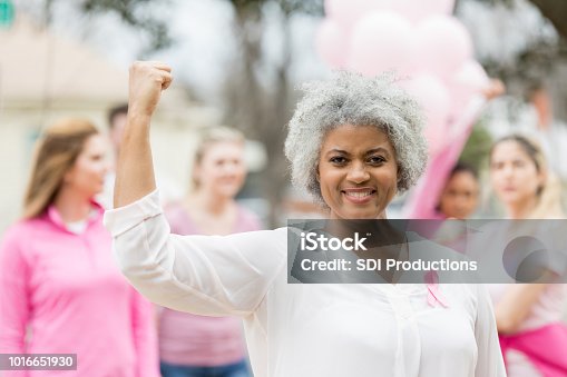 istock Strong breast cancer survivor flexing muscles 1016651930