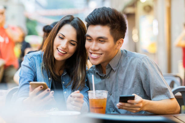 istock Cheerful young couple looking at smartphone 1016652042