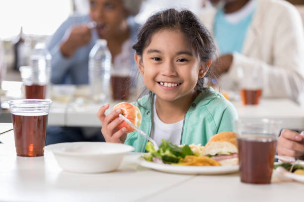 istock Little girl having lunch in soup kitchen 1016654948