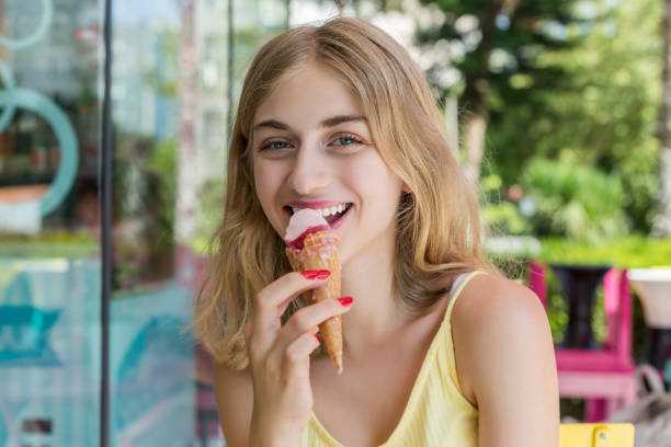 istock Young woman eating ice cream cone 1016658652