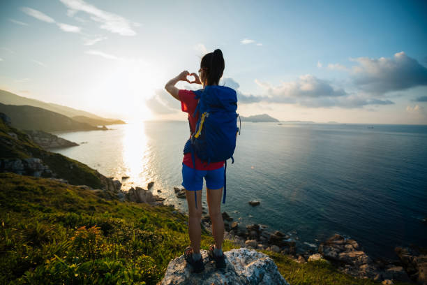 istock Woman hands making heart shape in sky 1016667426