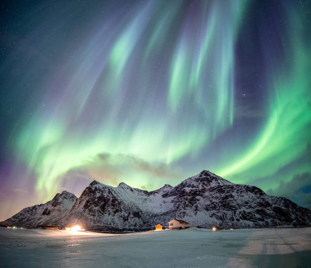 istock Fantastic Aurora borealis with starry dancing over snow mountain 1016673216