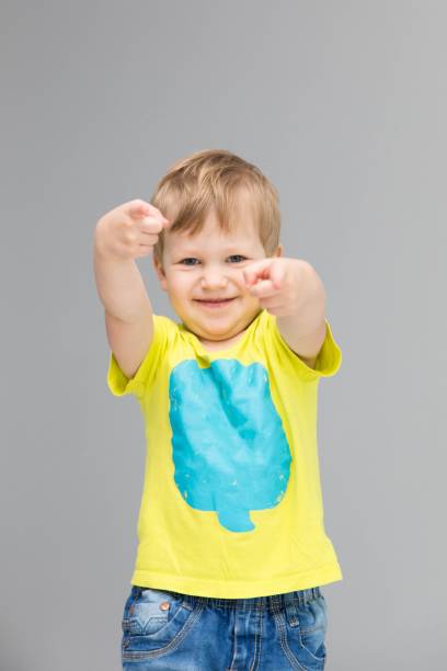istock little happy boy posing by the gray wall 1016681094