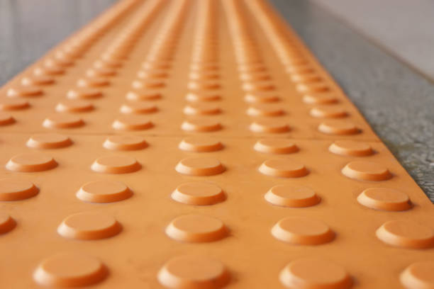 istock Tactile paving  is a system of textured ground surface indicator found on footpaths, stairs and train station platforms to assist pedestrians who are visually impaired 1016681140