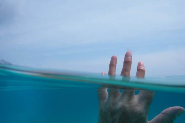 istock womans hand half submerged in water 1016682200