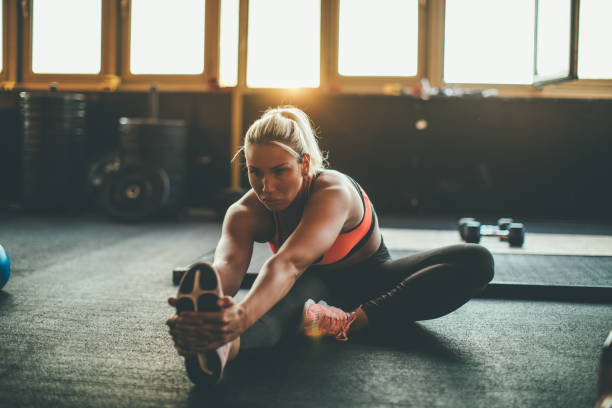 istock Woman stratching at the gym 1016684516