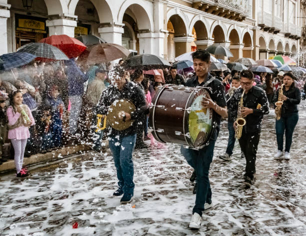 Cuenca, Ecuador, Feb 8, 2018: Parade goers happy in foam spray in Ecuador