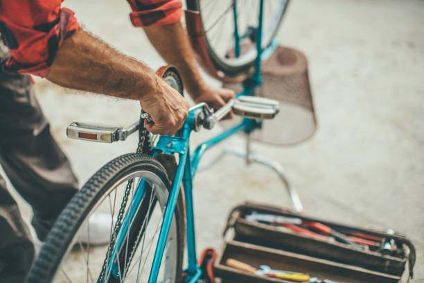 istock Mature man repairing bicycle in the front yard 1016689336