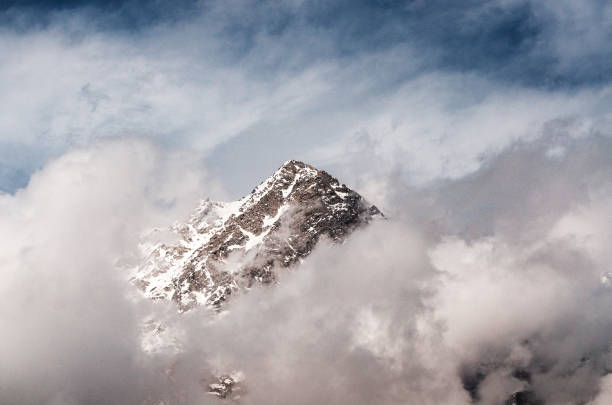 istock Snowy mountains in the clouds 1016690272