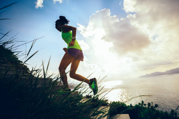 istock Determined woman running up on seaside mountain stairs 1016701564