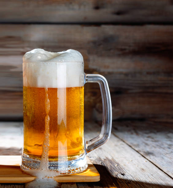 istock Mug of light beer on a wooden table 1016707662