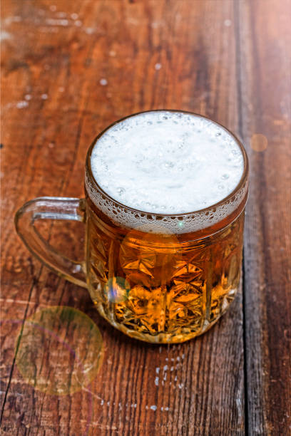 istock Mug, lager, beer, foam, wooden table, pub, Beer Fest, German b 1016708380