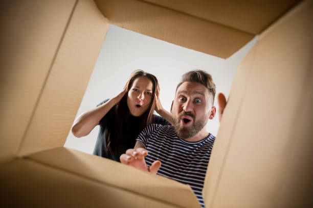 istock The couple unpacking and opening carton box and looking inside 1016720862