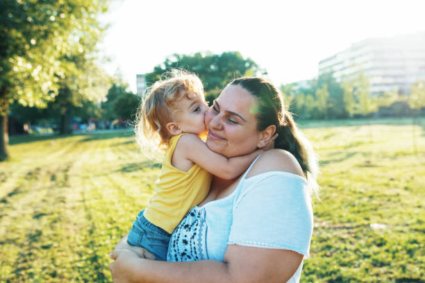 istock Three year old son kissing his mom 1016720870
