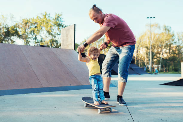 istock Modern dad with three year old son in skate park 1016721036